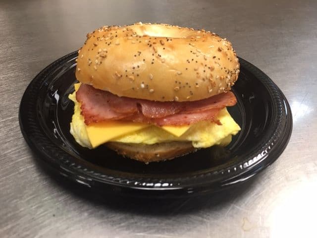 Bacon, egg and cheese on a fresh sesame bagel for an office breakfast